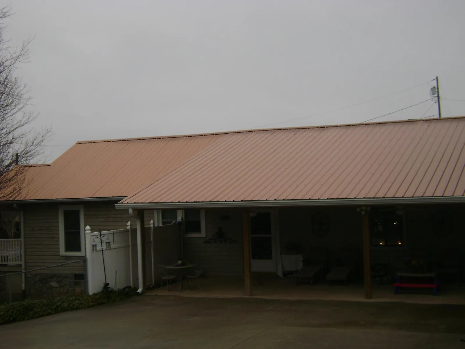 Copper toned metal roof over a wide covered patio in Somerset